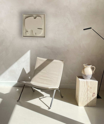 Plant-based PLA artwork with sand texture and eco-paint in a modern interior setting.