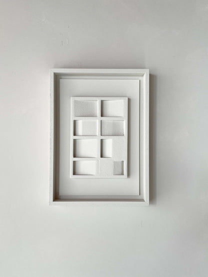 Eco-friendly white artwork titled "23.3 Pella" made from plant-based PLA with sand texture and eco-paint in a white frame.