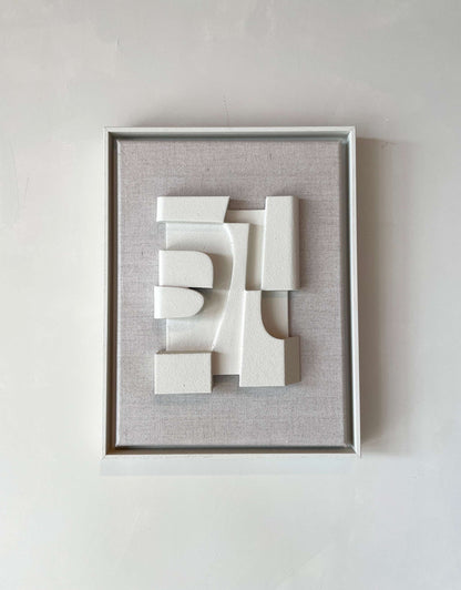 Canvas Jonna artwork with shadow white frame and textured plaster surface.