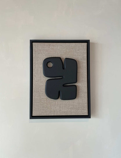Canvas Noa with anthracite black artwork on beige background, framed in anthracite black.