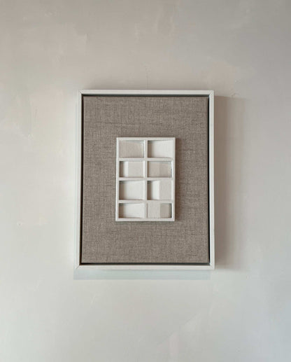 Canvas Pella artwork with shadow white frame and structured plaster finish.