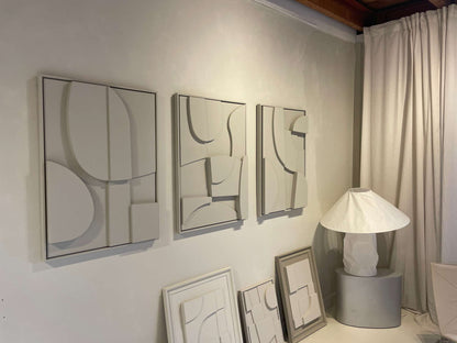 Handmade abstract art pieces on wall, featuring sand texture and eco-paint.