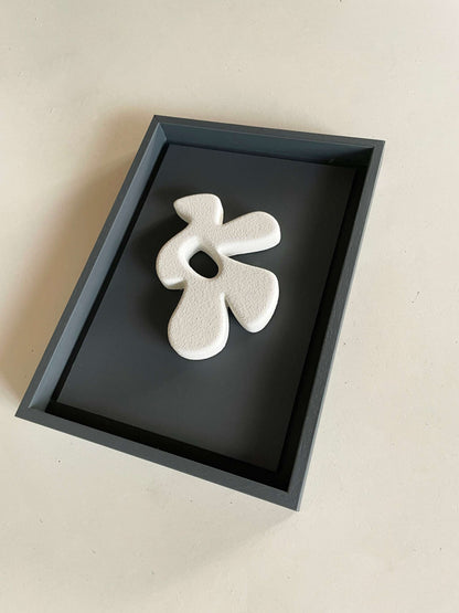 23.1 Bird artwork made from biodegradable PLA with sand texture and eco-paint, displayed in a black frame.