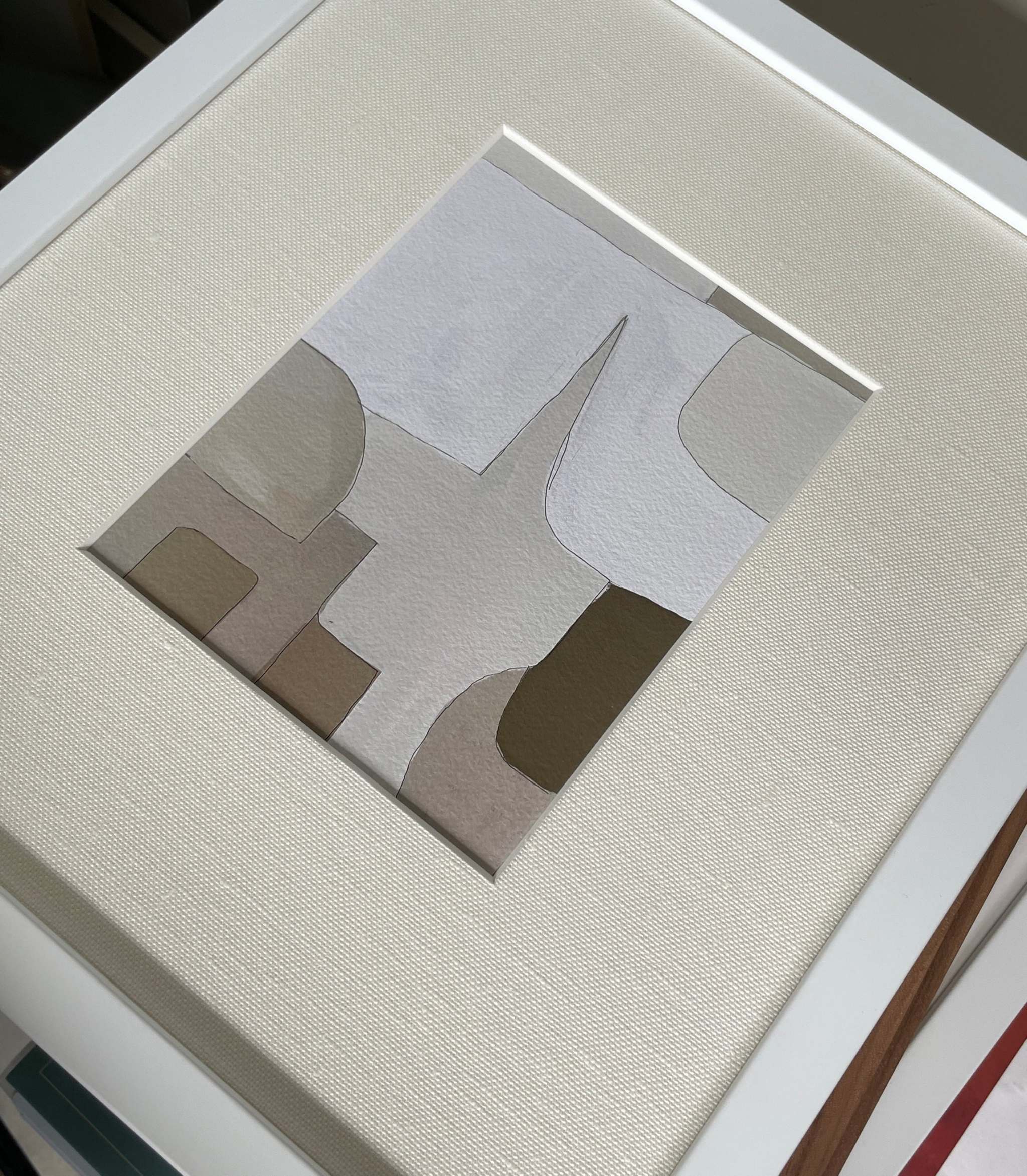 Art print 'Joya' featuring abstract design with beige and white tones, displayed in a white mat frame.
