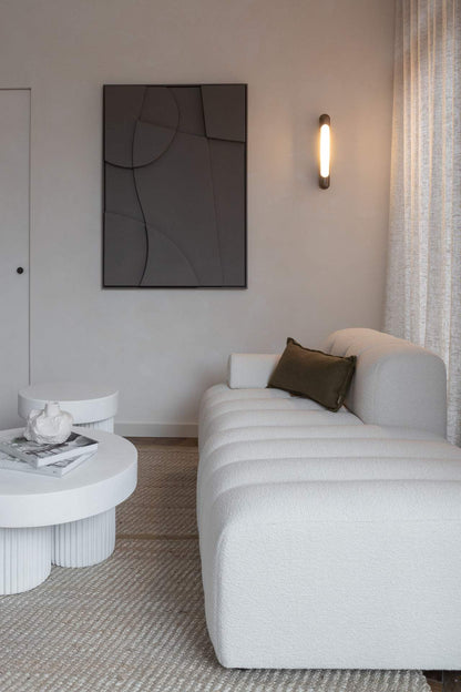 Modern living room featuring '#21.21 Charlie' wall art, displayed above a cozy sofa with textured decor elements.