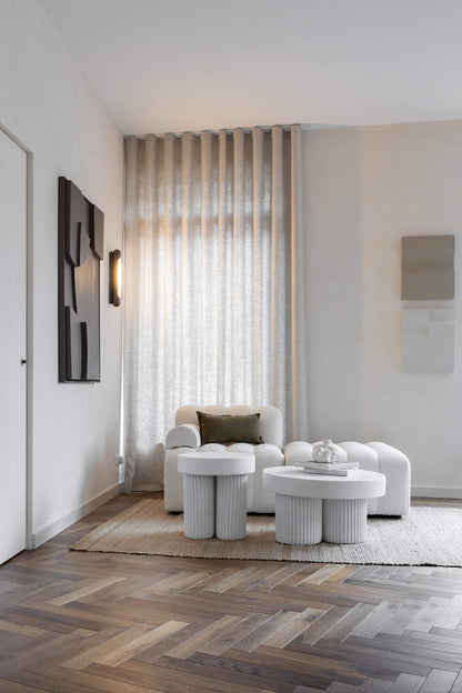 Modern living room with minimalist art pieces on the wall.