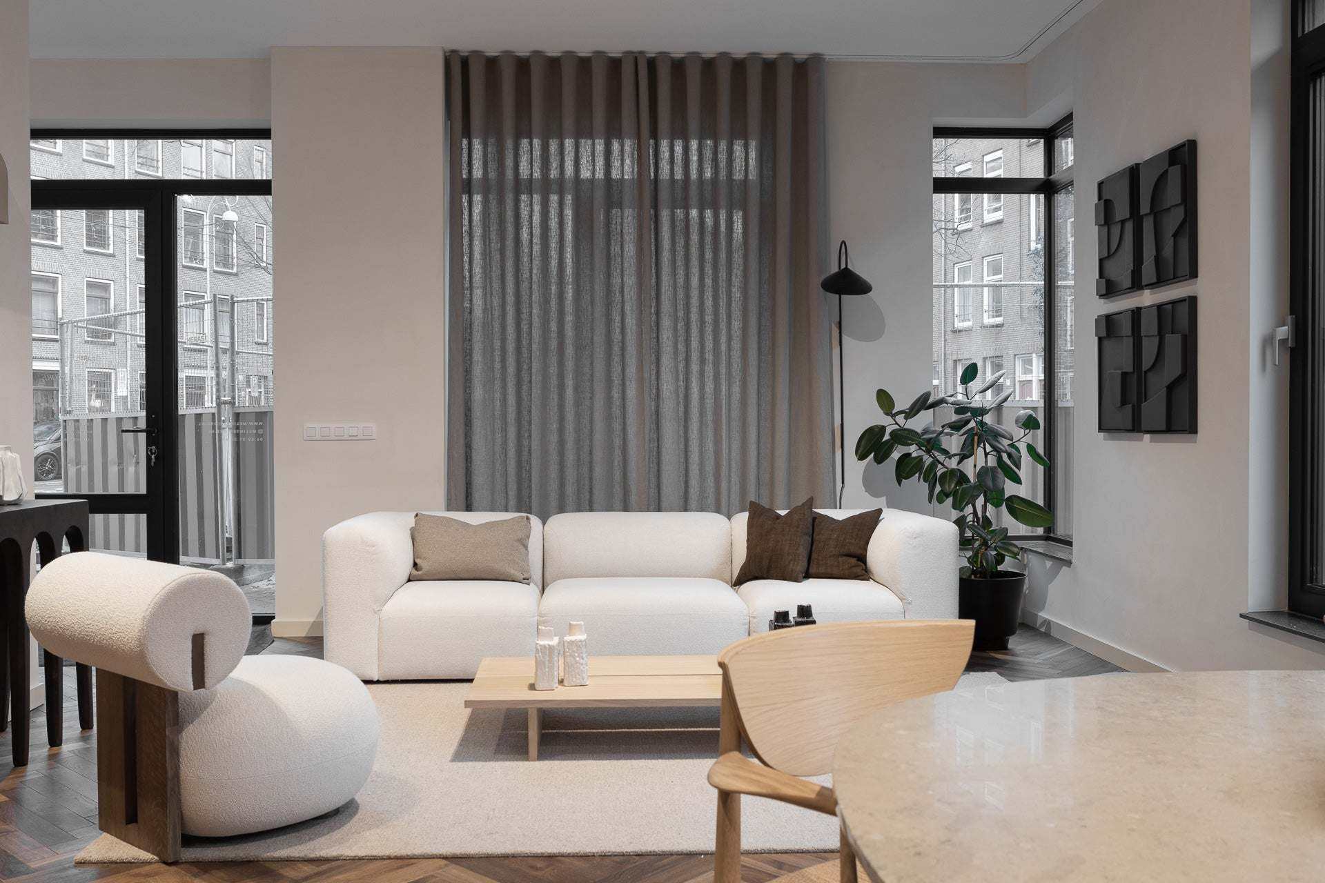 Minimalist living room interior featuring 'Quartet - Tête à Tête' furniture with eco-friendly materials.