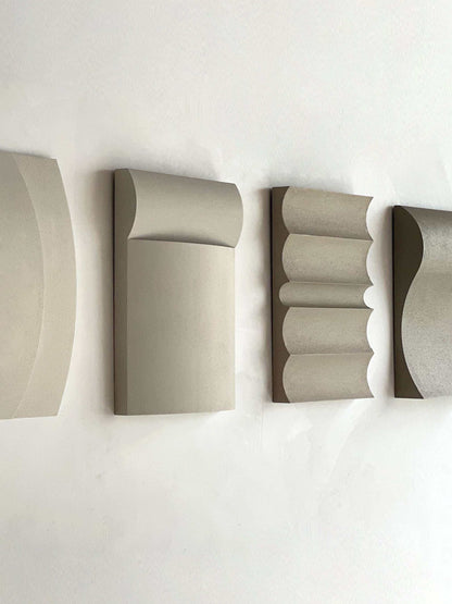 Contemporary wall art in white, shadow white, dark lime, brown wood, and mud grey finishes.