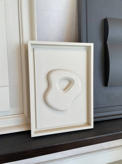 Organic Stone artwork by Edith Beurskens with sand texture in shadow white frame, size 30x21 cm.